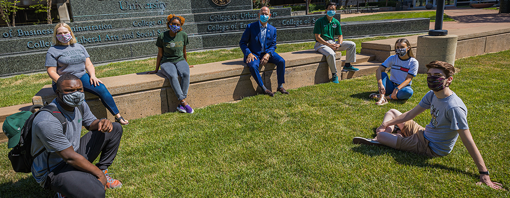 Cleveland State University President Sands and Provost Zhu with students outside wearing masks